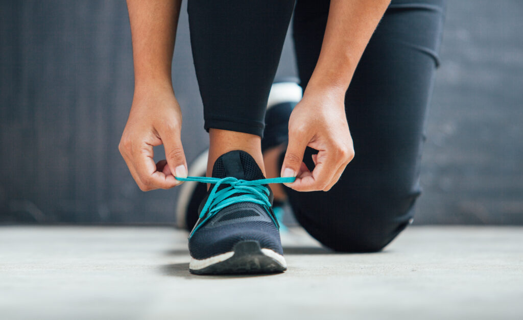 Close up image of a woman tying her shoelaces